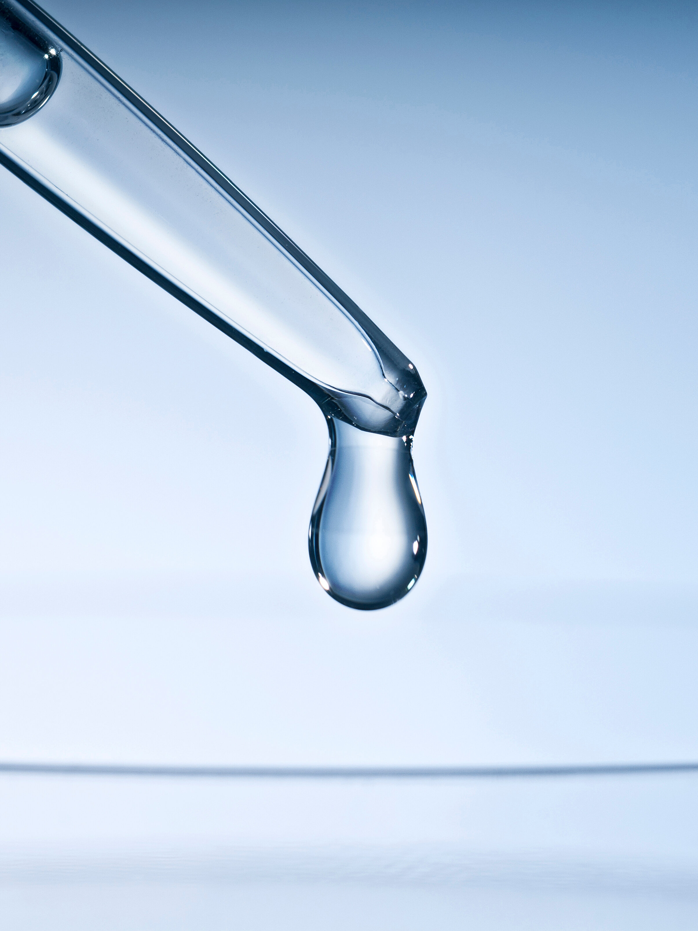A drop falling from a pipette
