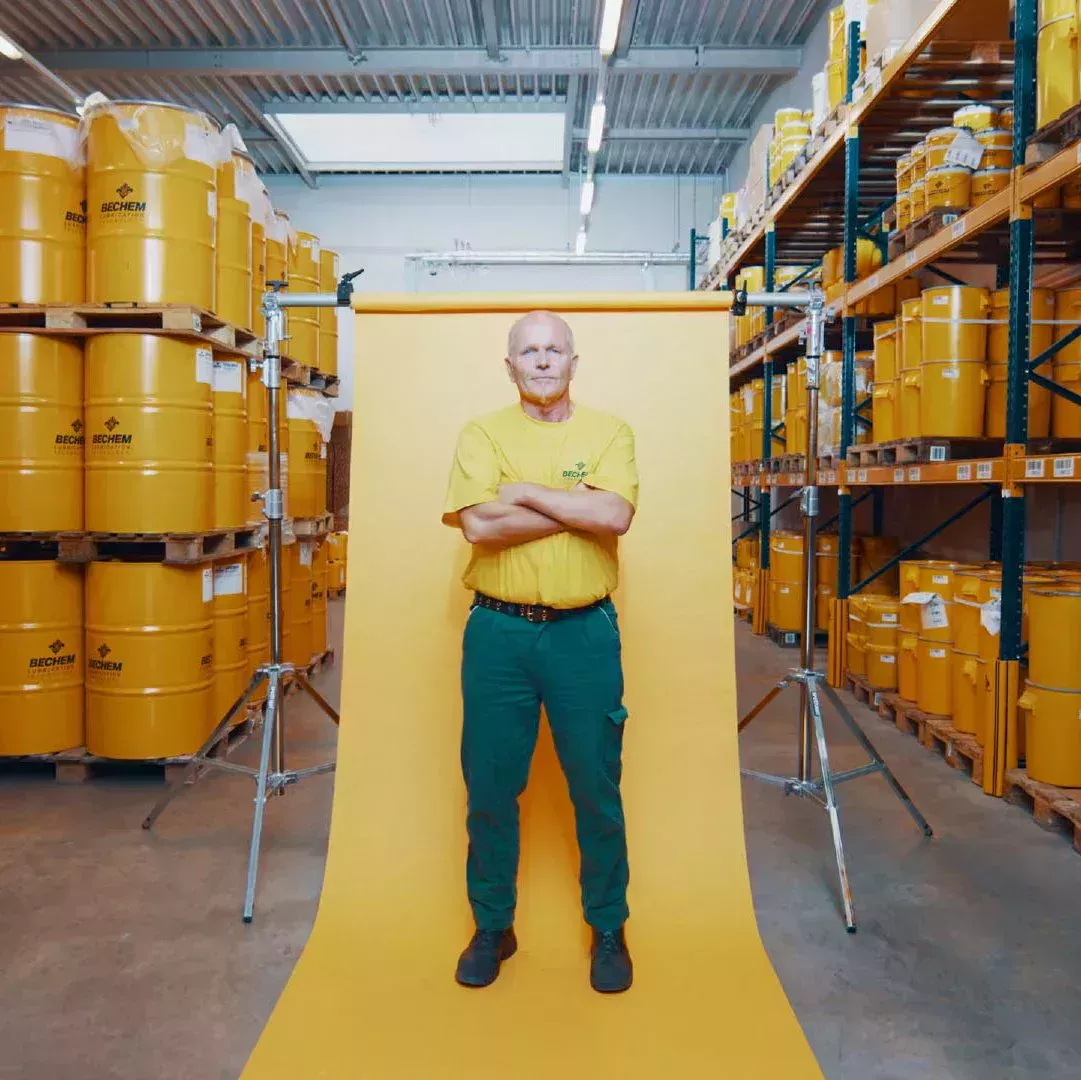 Man standing in front of a yellow wall in the BECHEM logistics centre