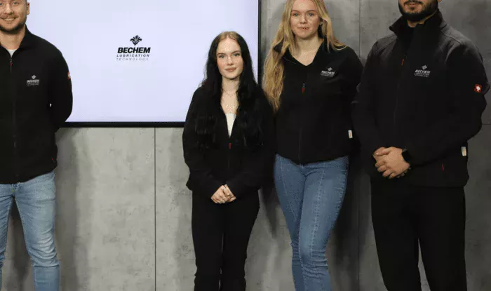 Four people stand in the film studio and present