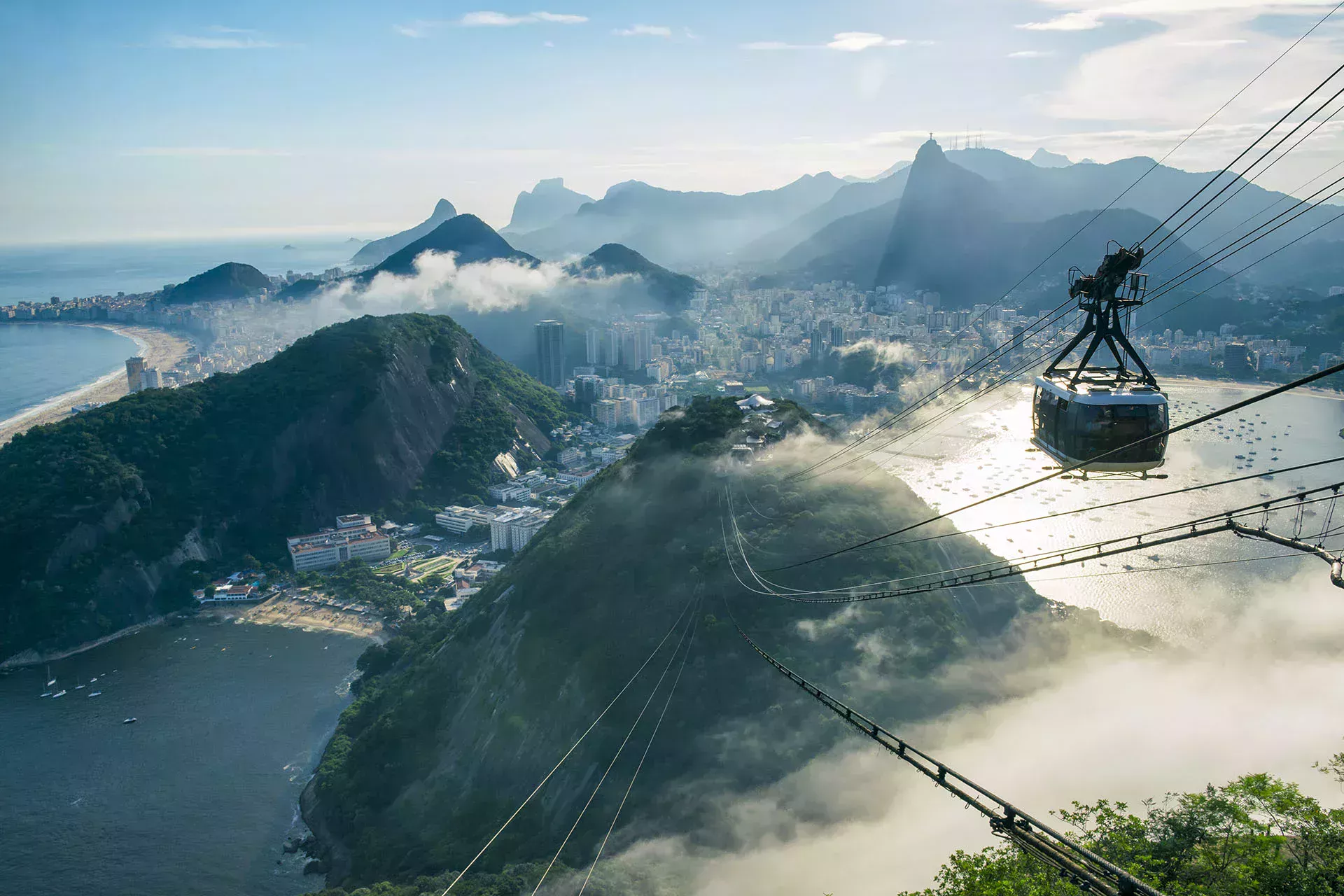 Cable car over mountains and a city