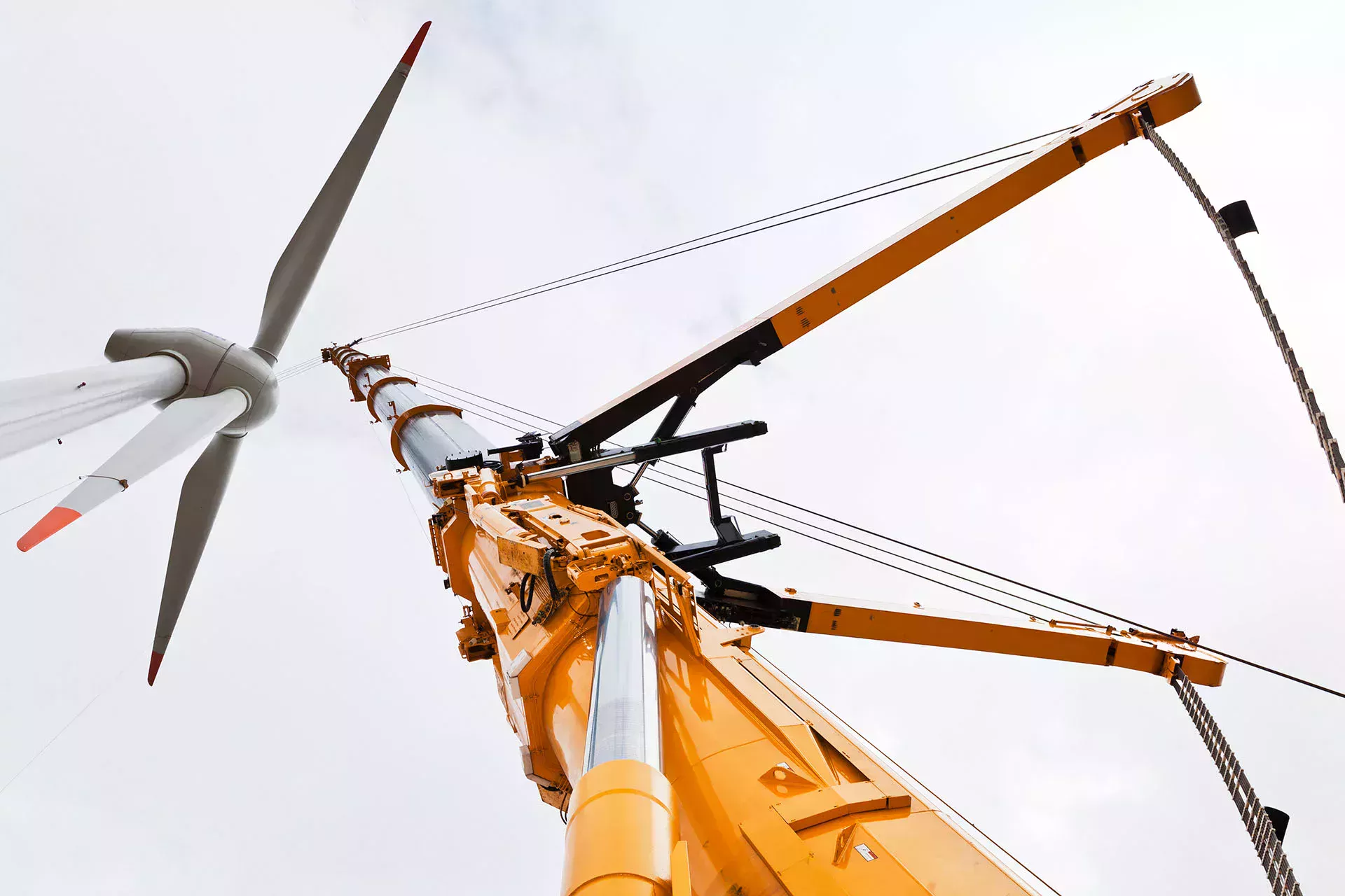 Yellow crane hoist erecting wind turbines