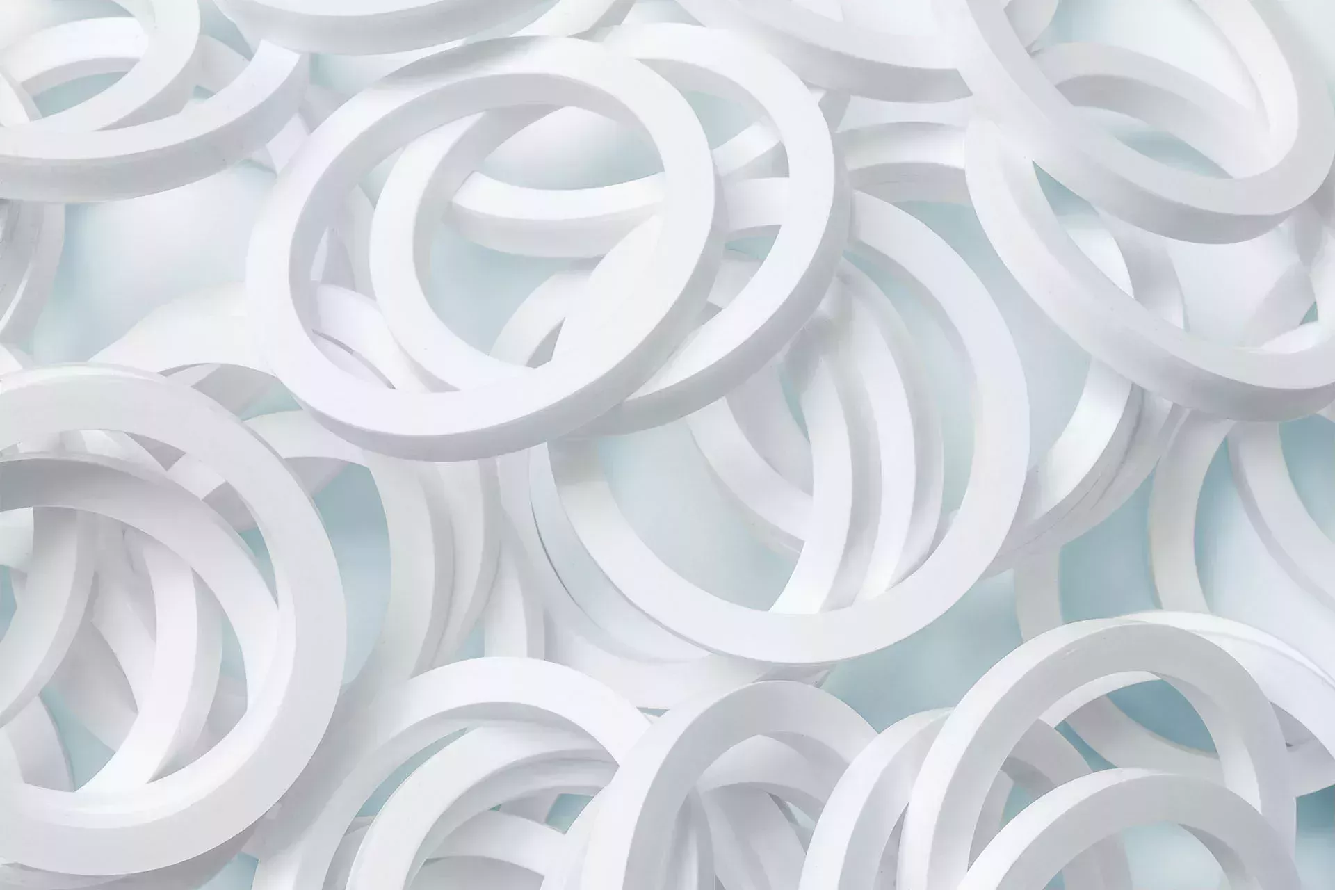 Lots of white O-rings on a light blue background