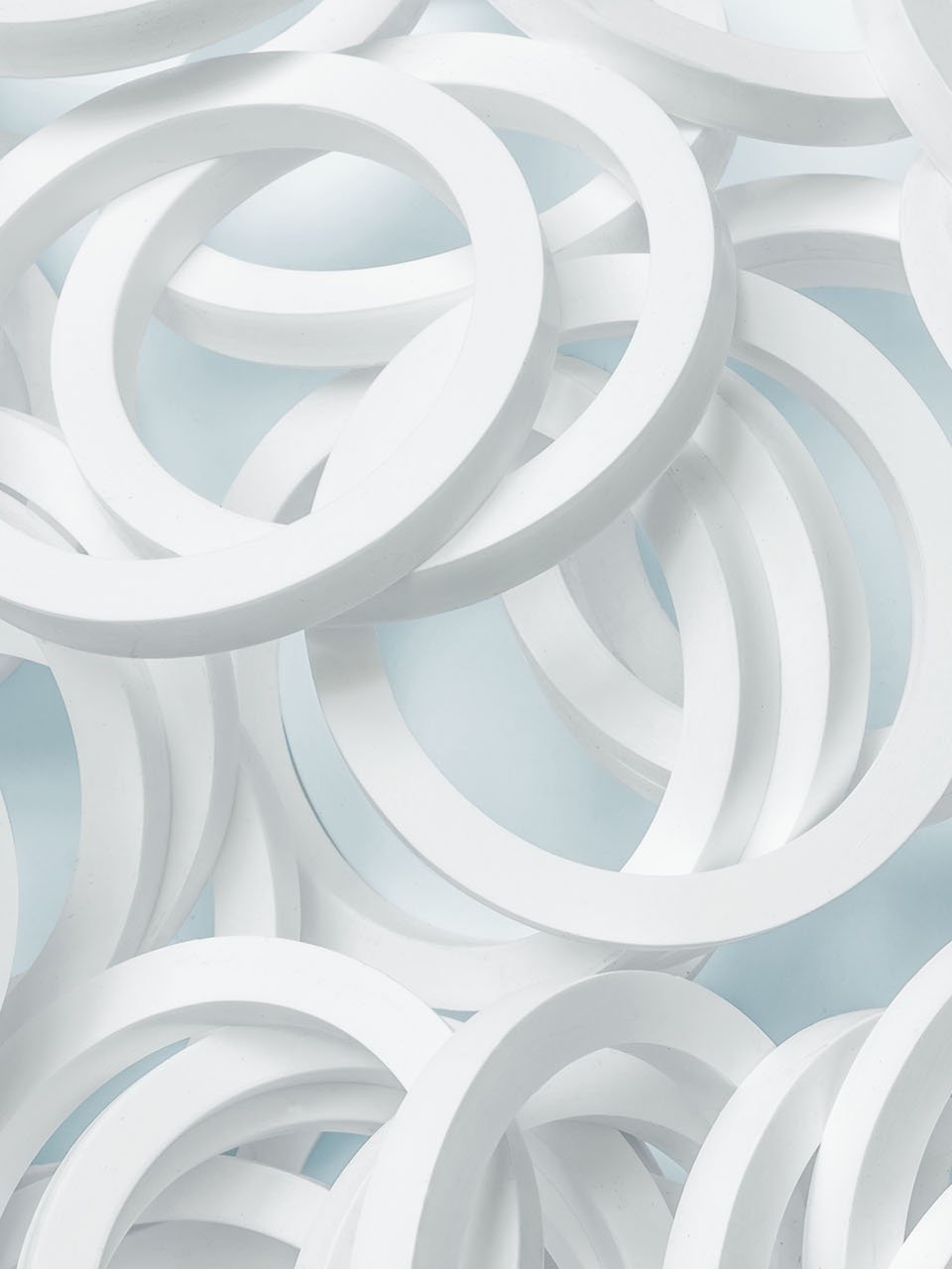 Lots of white O-rings on a light blue background