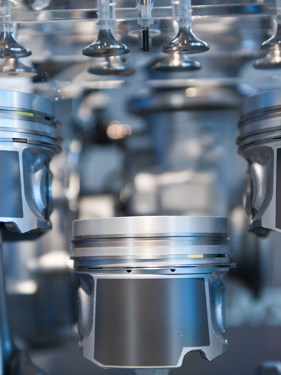 Pistons for bonded coatings