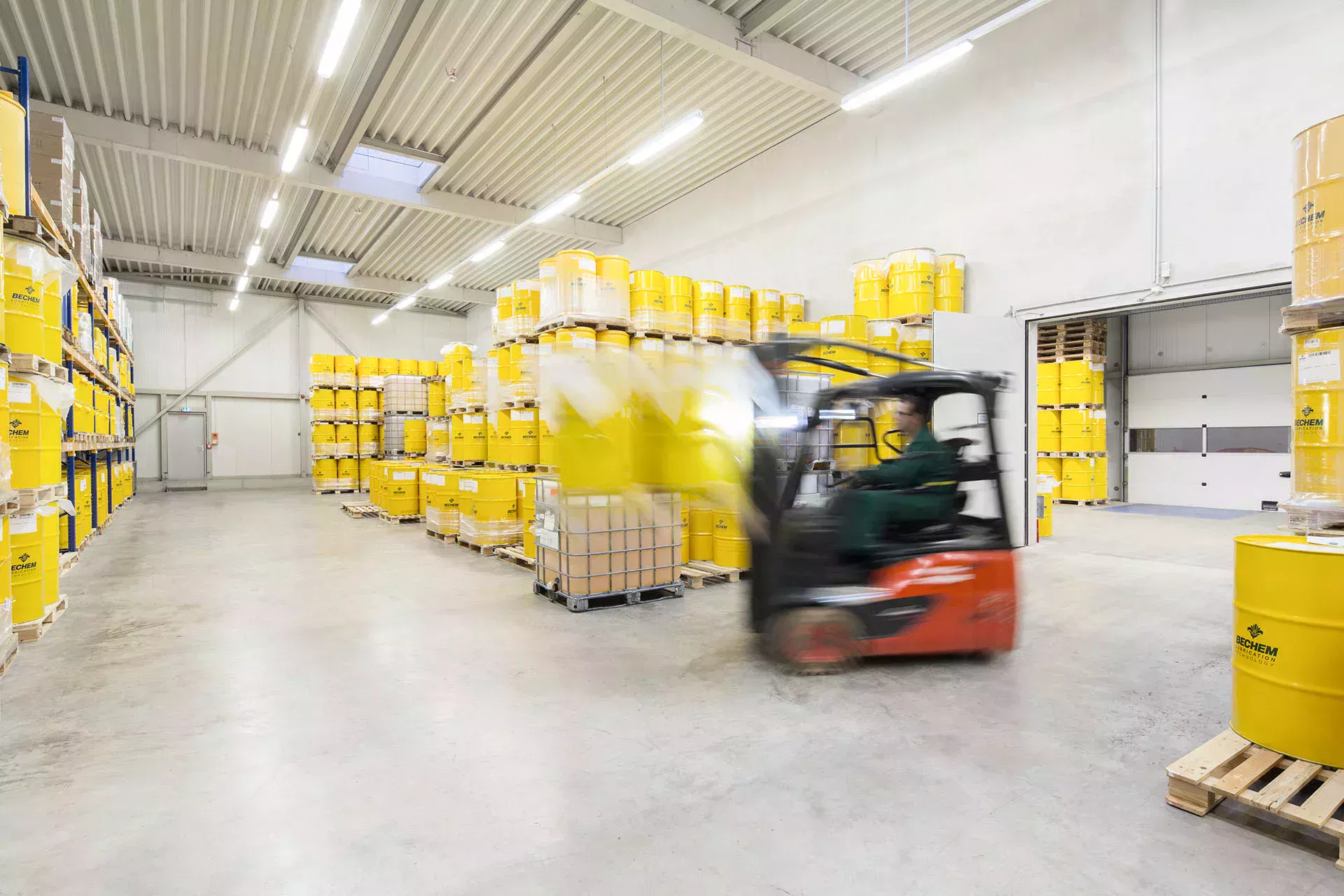 Forklift truck transports barrels at the BECHEM logistics center