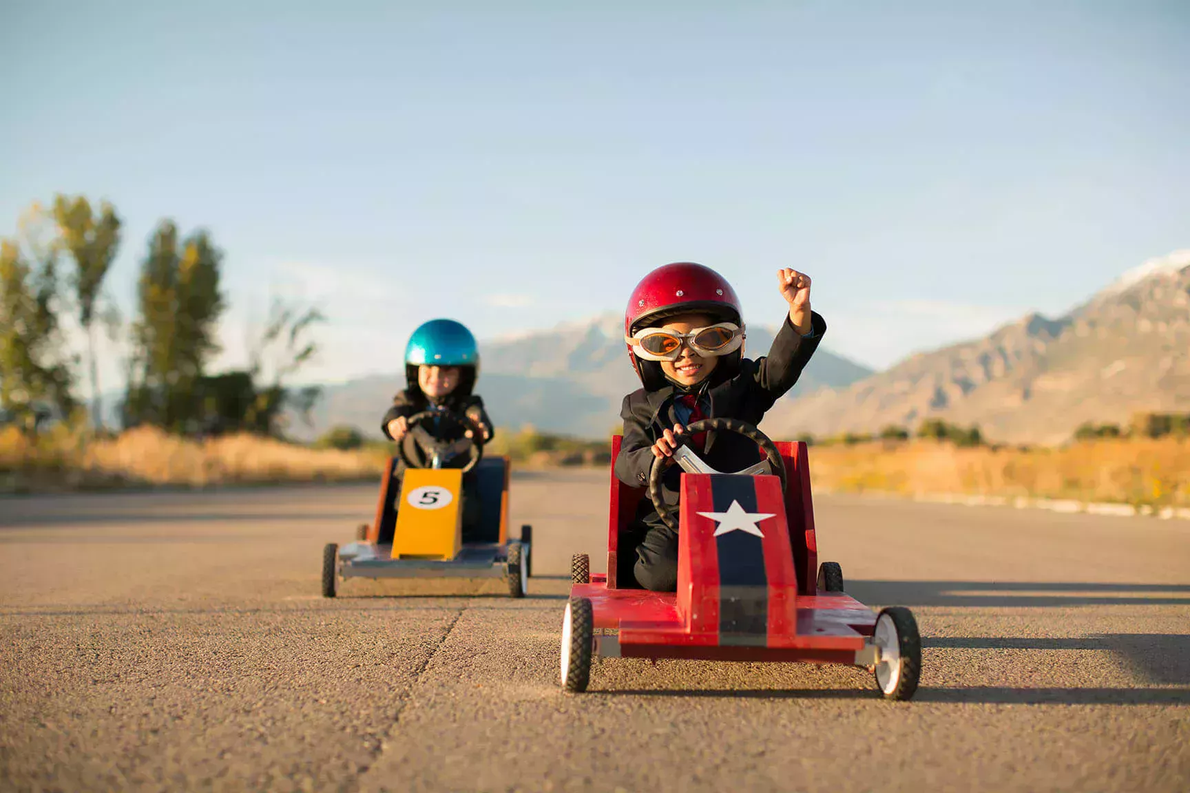 Two children race a car